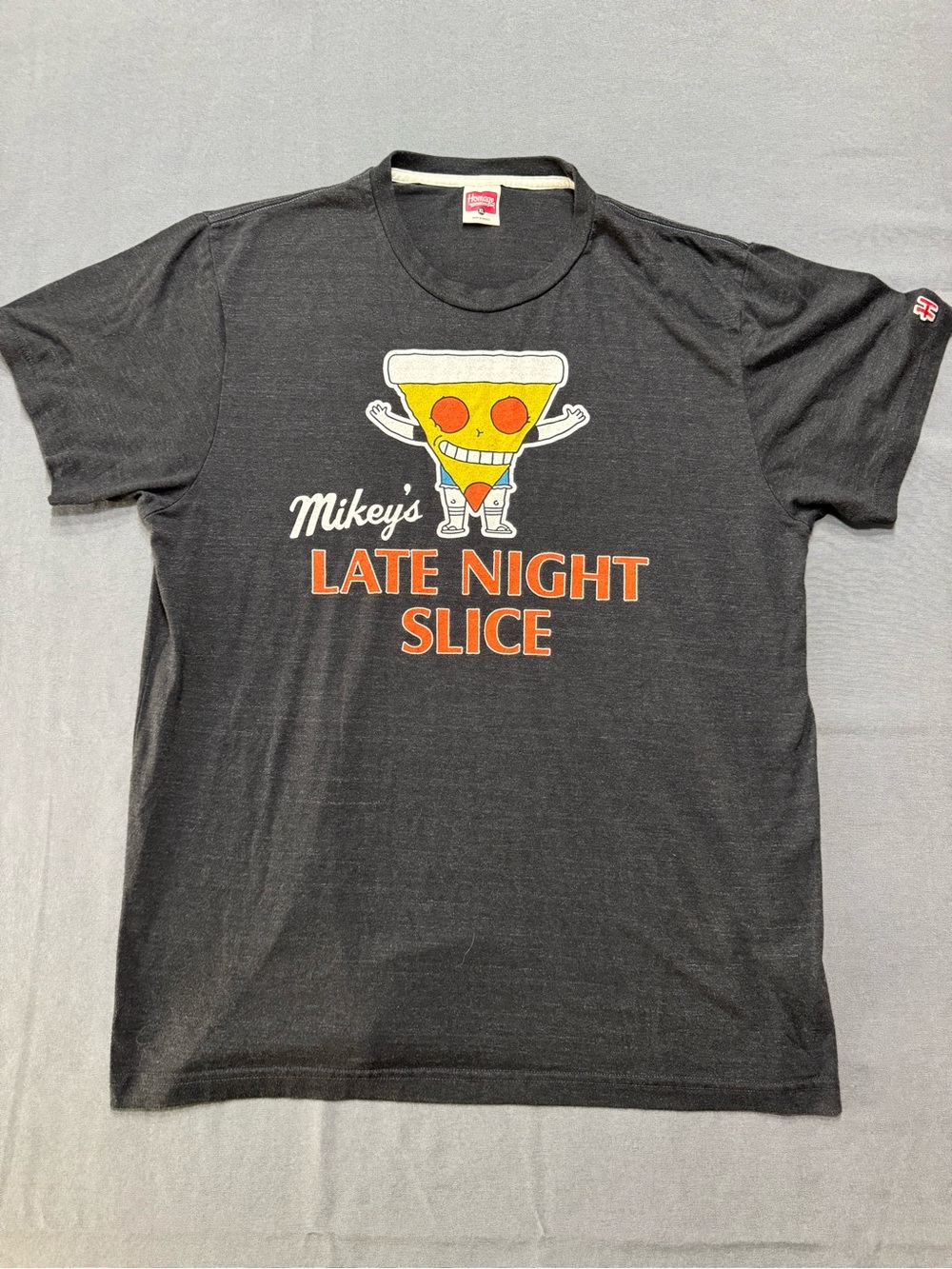 HOMAGE Black Tee with Yellow Pizza Slice and Orange Text